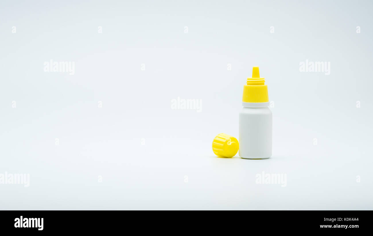 Eye drops bottle with open yellow cap isolated on white background with blank label and copy space, just add your own text. Stock Photo