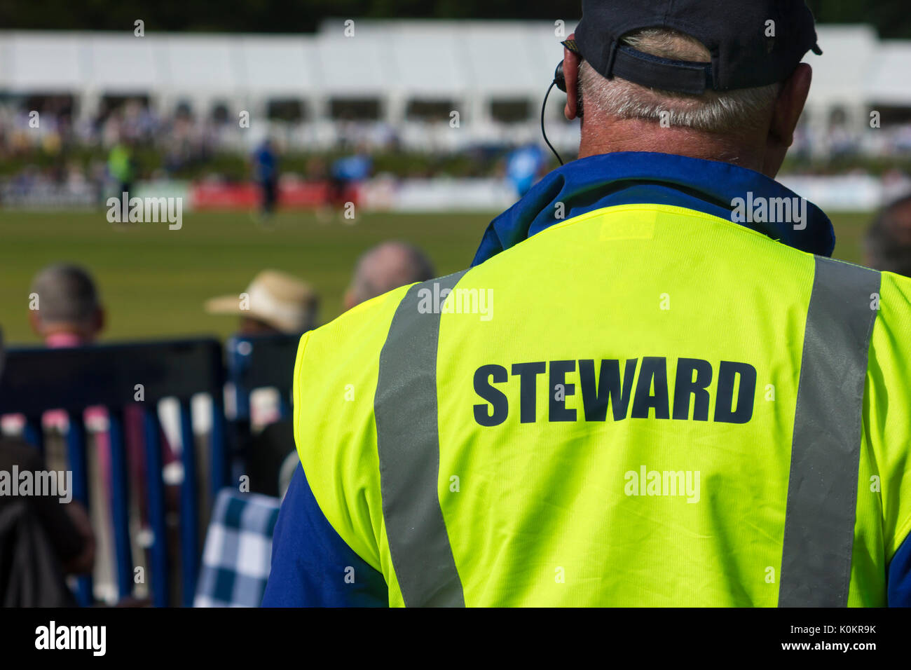 Sports steward by pitch in high viz jacket Stock Photo
