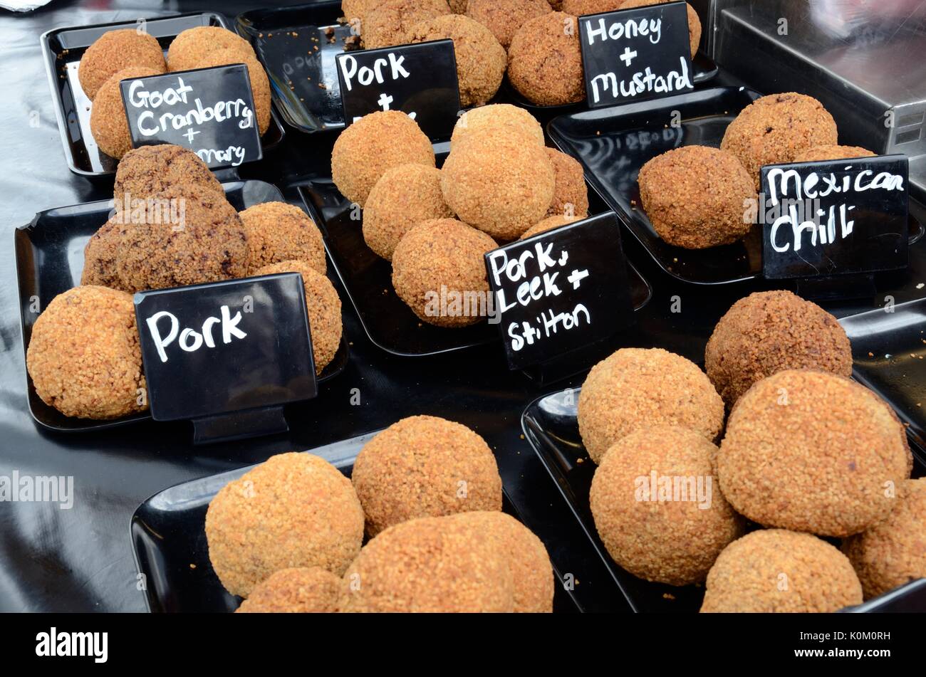 Variety of scotch eggs for sale at a food festival Swansea food Festival Stock Photo