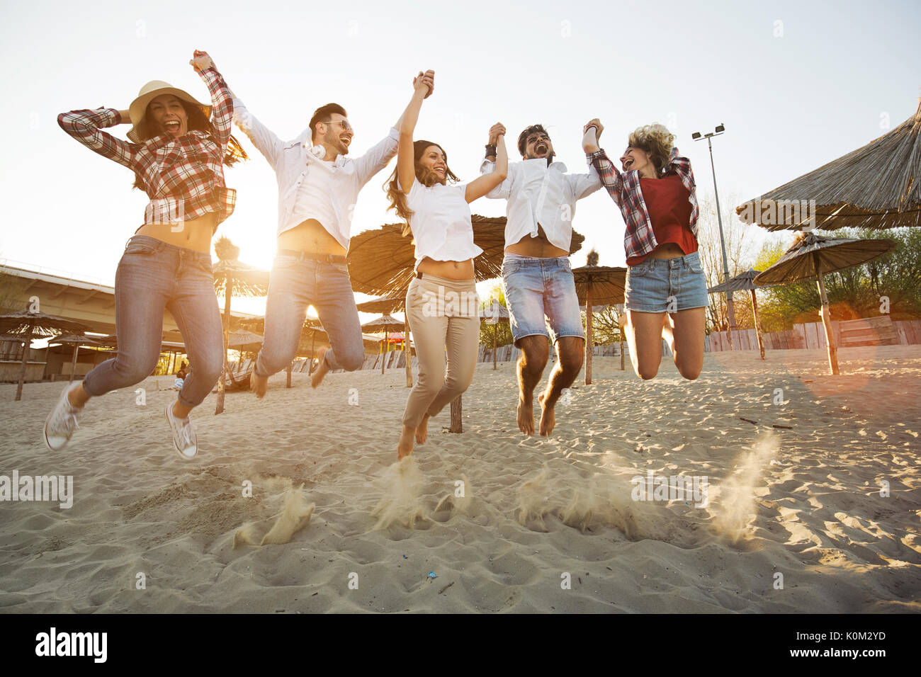 Group of friends on beach having fun Stock Photo