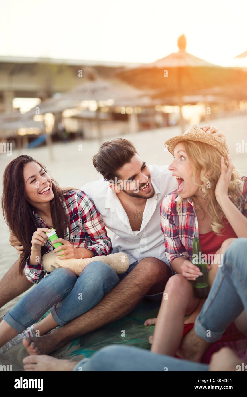 Group of cheerful friends having great time at beach Stock Photo