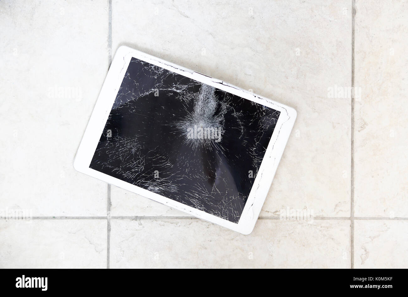 Damaged or broken tablet computer lcd display on the floor Stock Photo