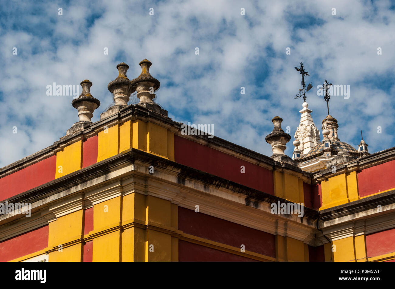 Spain: the skyline and saturated colors, typical of Seville, seen on the external wall of the the Alcazar, the famous royal palace of the city Stock Photo