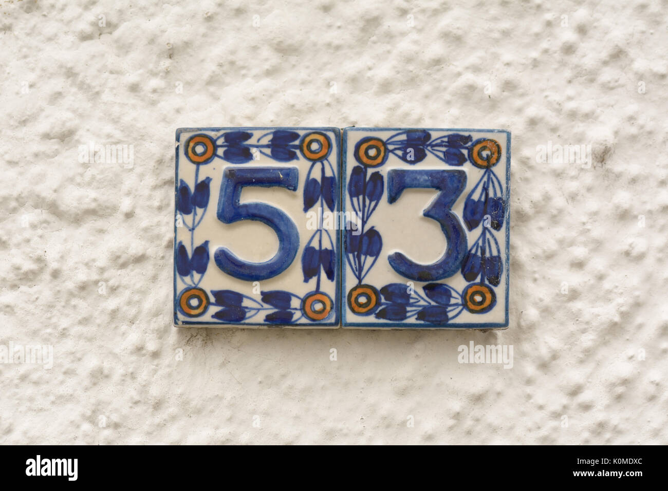House number 53 ceramic sign on wall Stock Photo