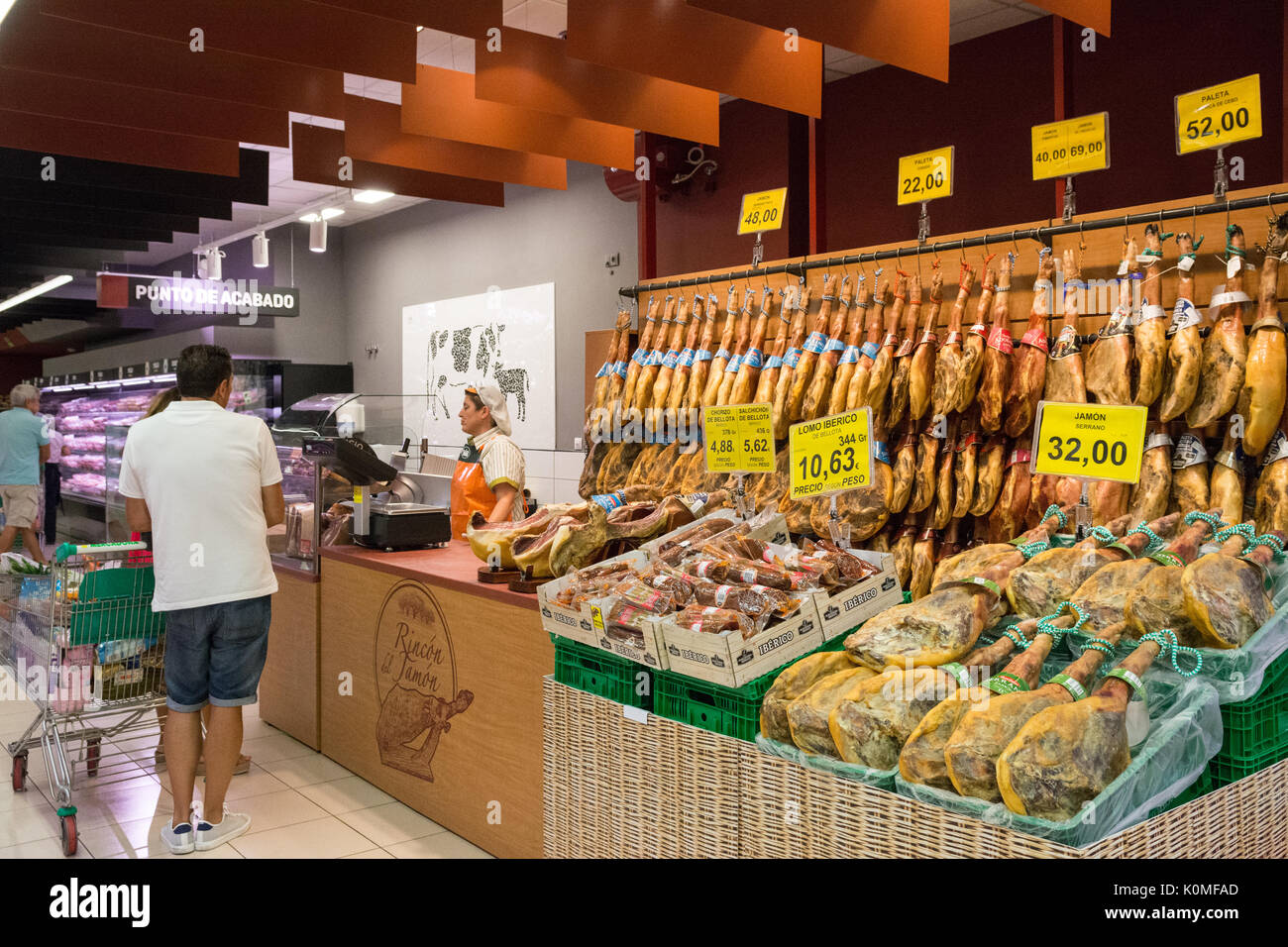 jamon - dry cured ham legs - at typical Spanish supermarket Stock Photo