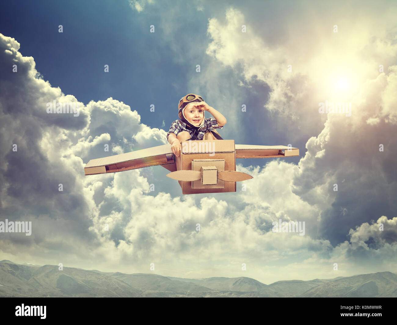 little kid enjoy with his cardboard airplane Stock Photo