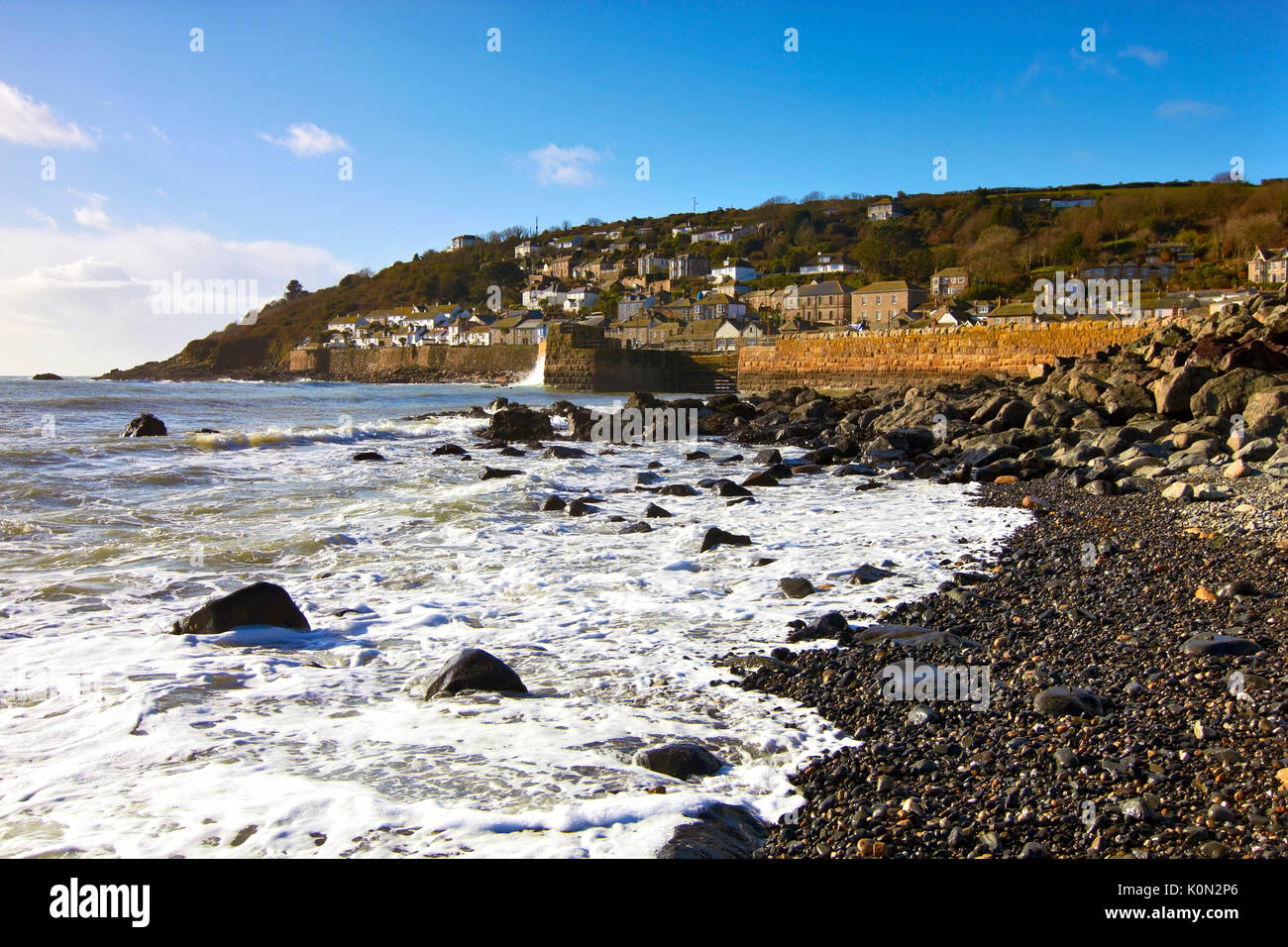 A view along the pebbled coast of Mousehole, Cornwall, UK Stock Photo
