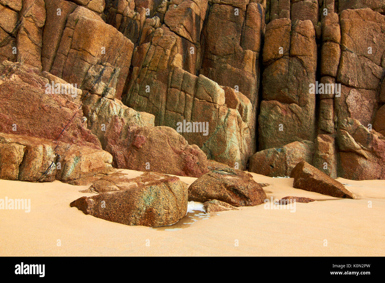 A close up view of the colourful cliffs of Porthcurno Beach, Cornwall, UK Stock Photo