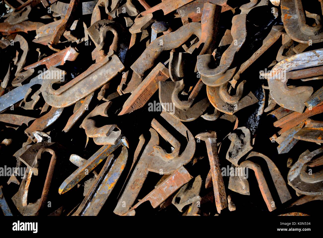 Rusted pile of railroad track spikes and anchors Stock Photo