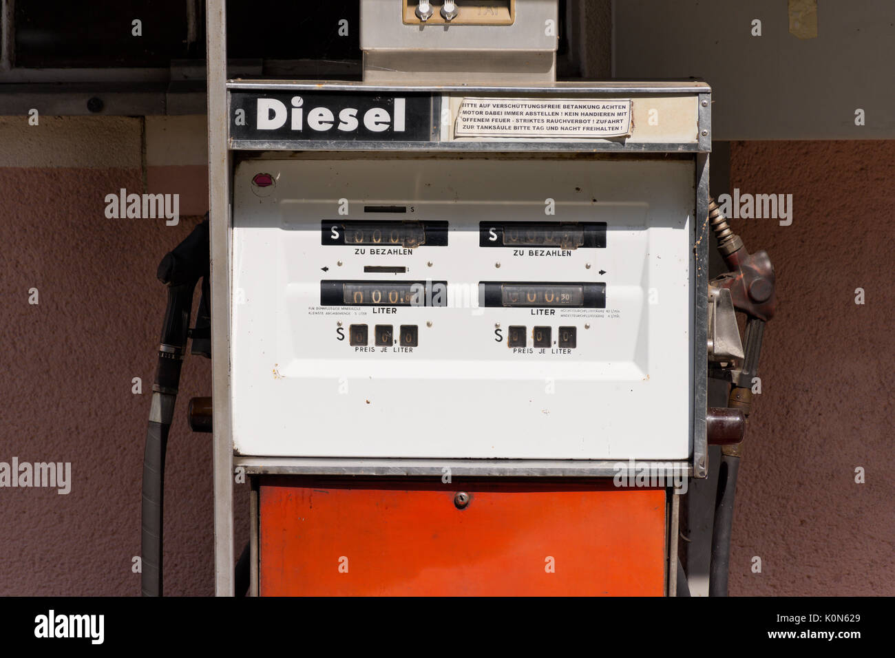 Old diesel petrol pump in Austria. Filling station in front of pink