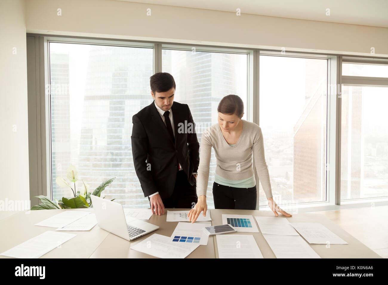 Creative interior designers sharing ideas, discussing color sche Stock Photo