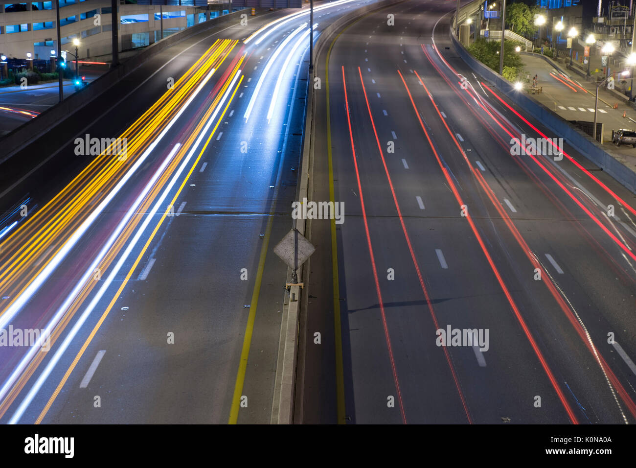 Streaks of lights from headlights and taillights from highway traffic, overhead view. Stock Photo