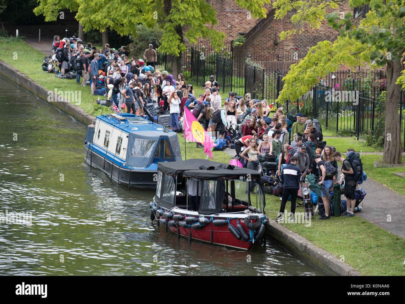 Festival goers arriving for the Reading Festival in Richfield Avenue, Reading, Berkshire, which starts on Friday. Stock Photo