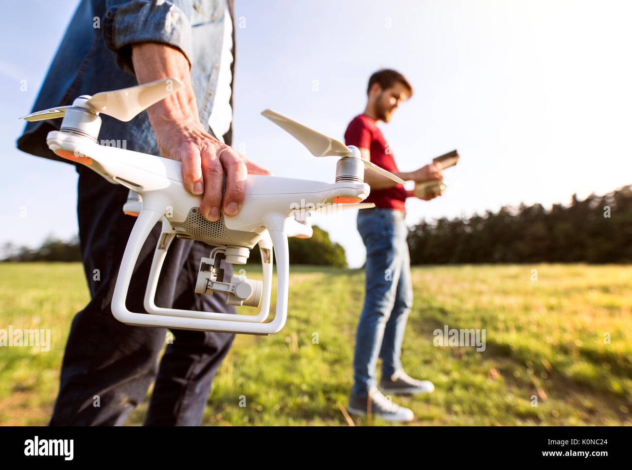 Senior father and his adult son with drone on a meadow Stock Photo - Alamy