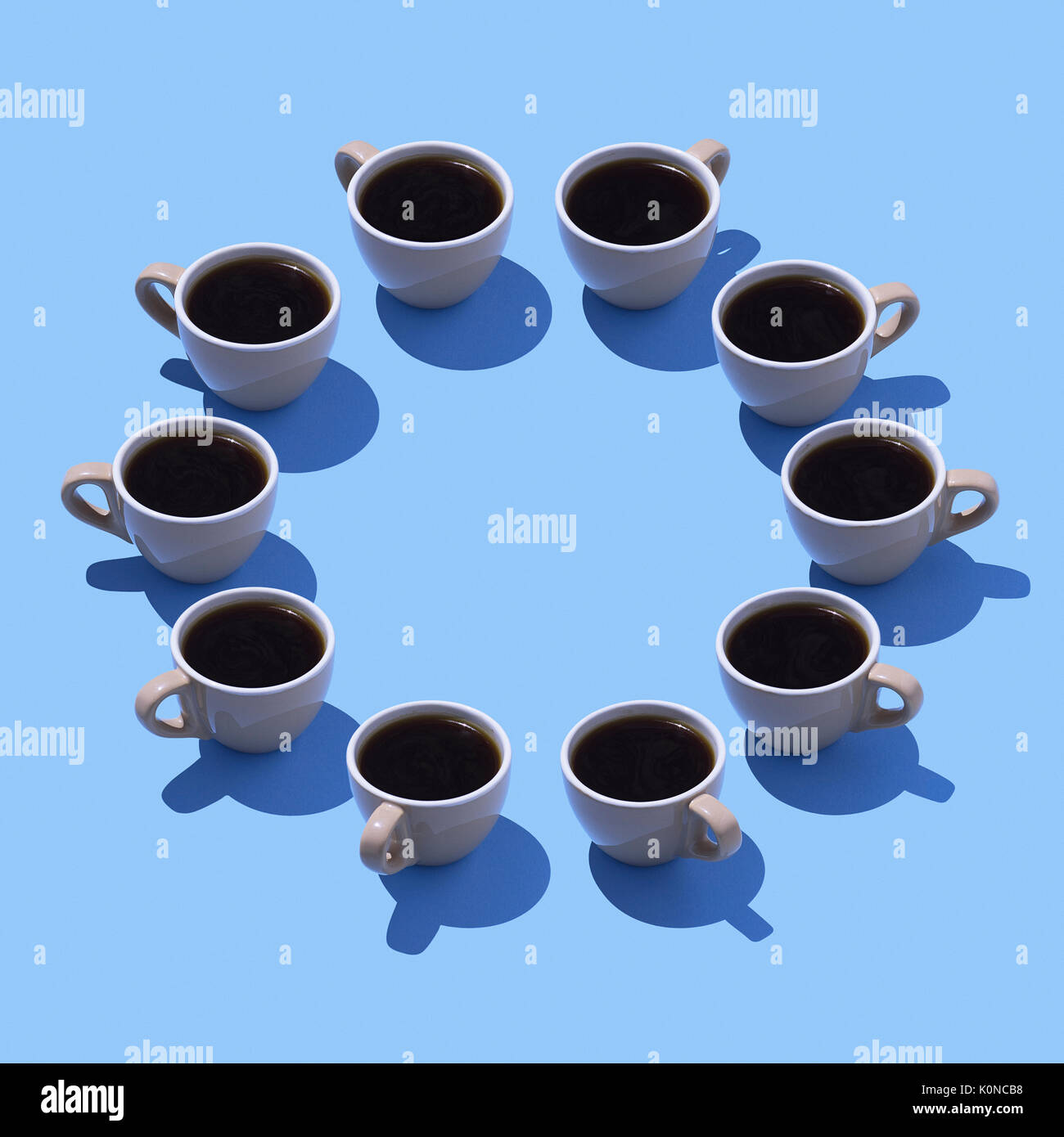 Coffee cups building circle on light blue ground, 3D Rendering Stock Photo