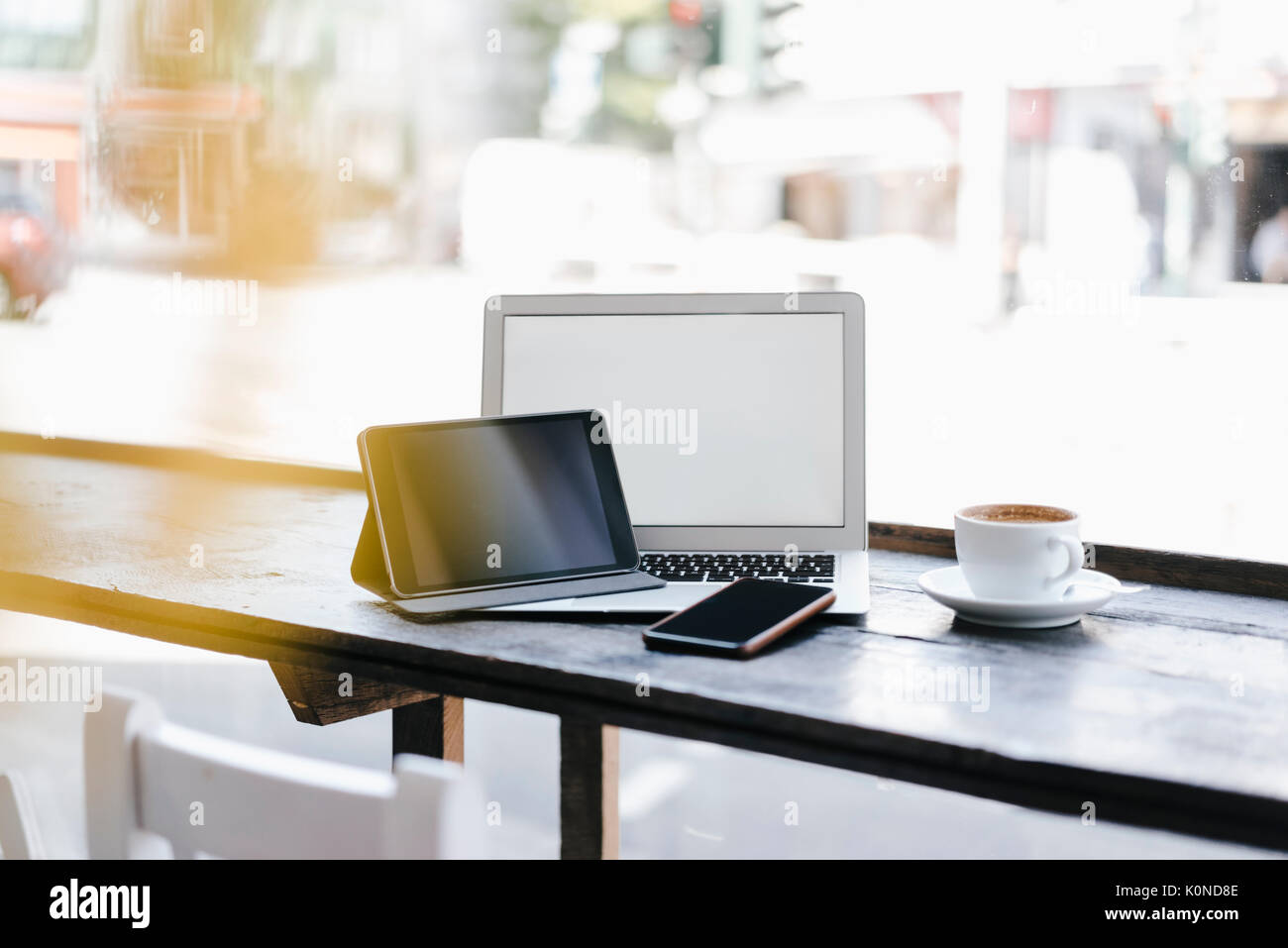 Mobile devices in cafe by cup of coffee Stock Photo Alamy