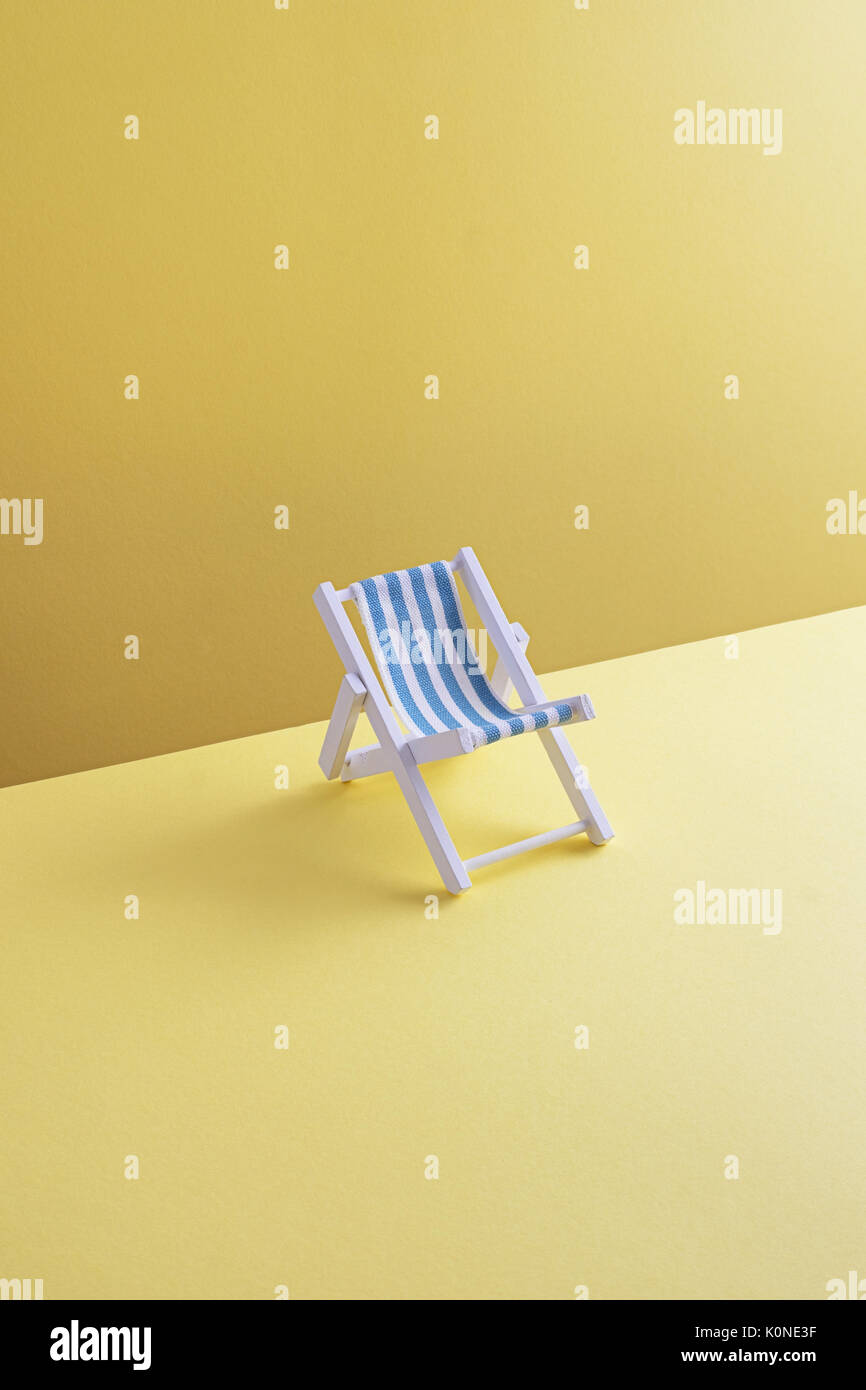 Single beach chair on yellow ground, 3D Rendering Stock Photo