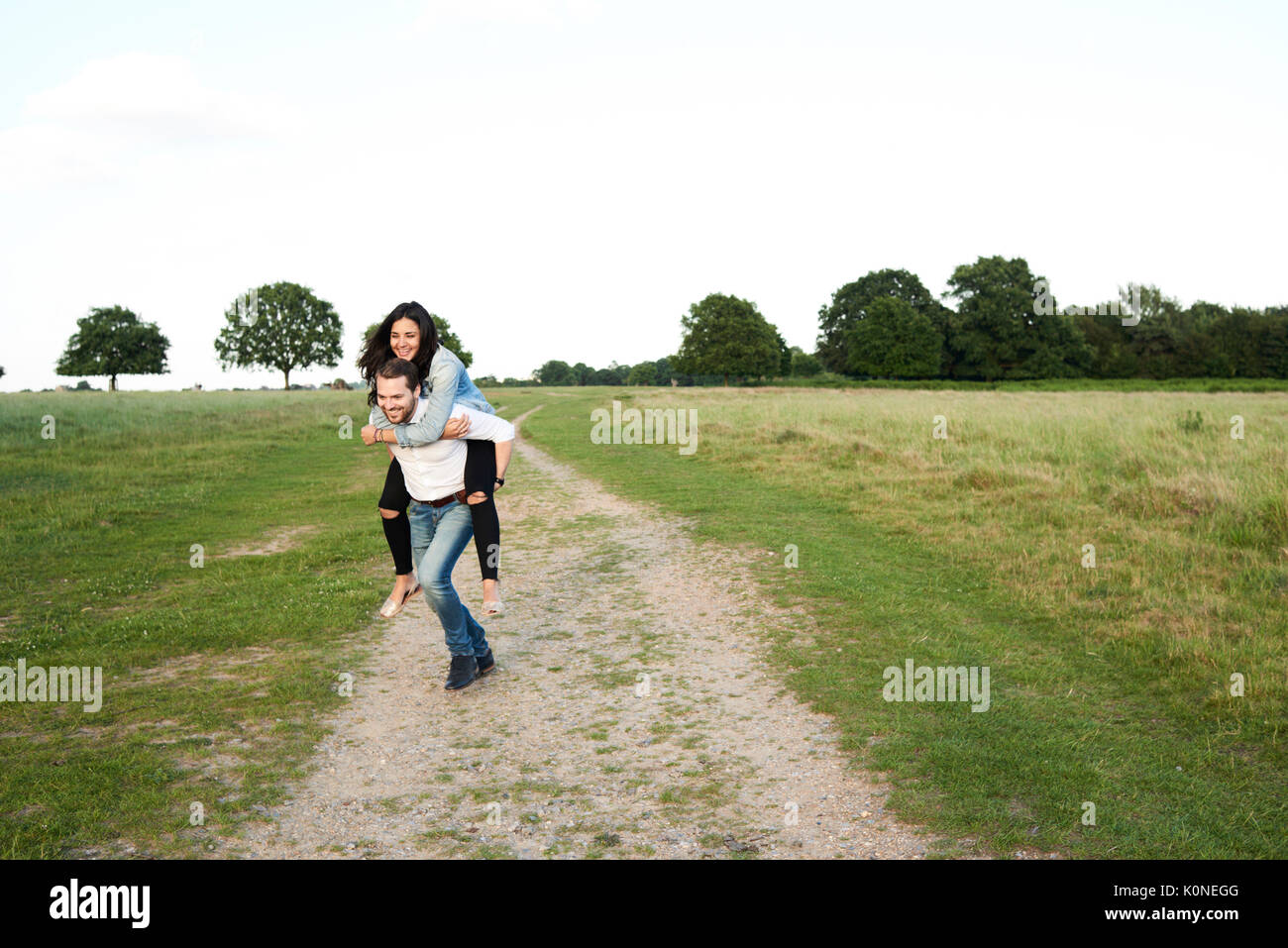 Hampstead Heath, London, UK, smiley couple playing outdoors, couple sunset at park Stock Photo