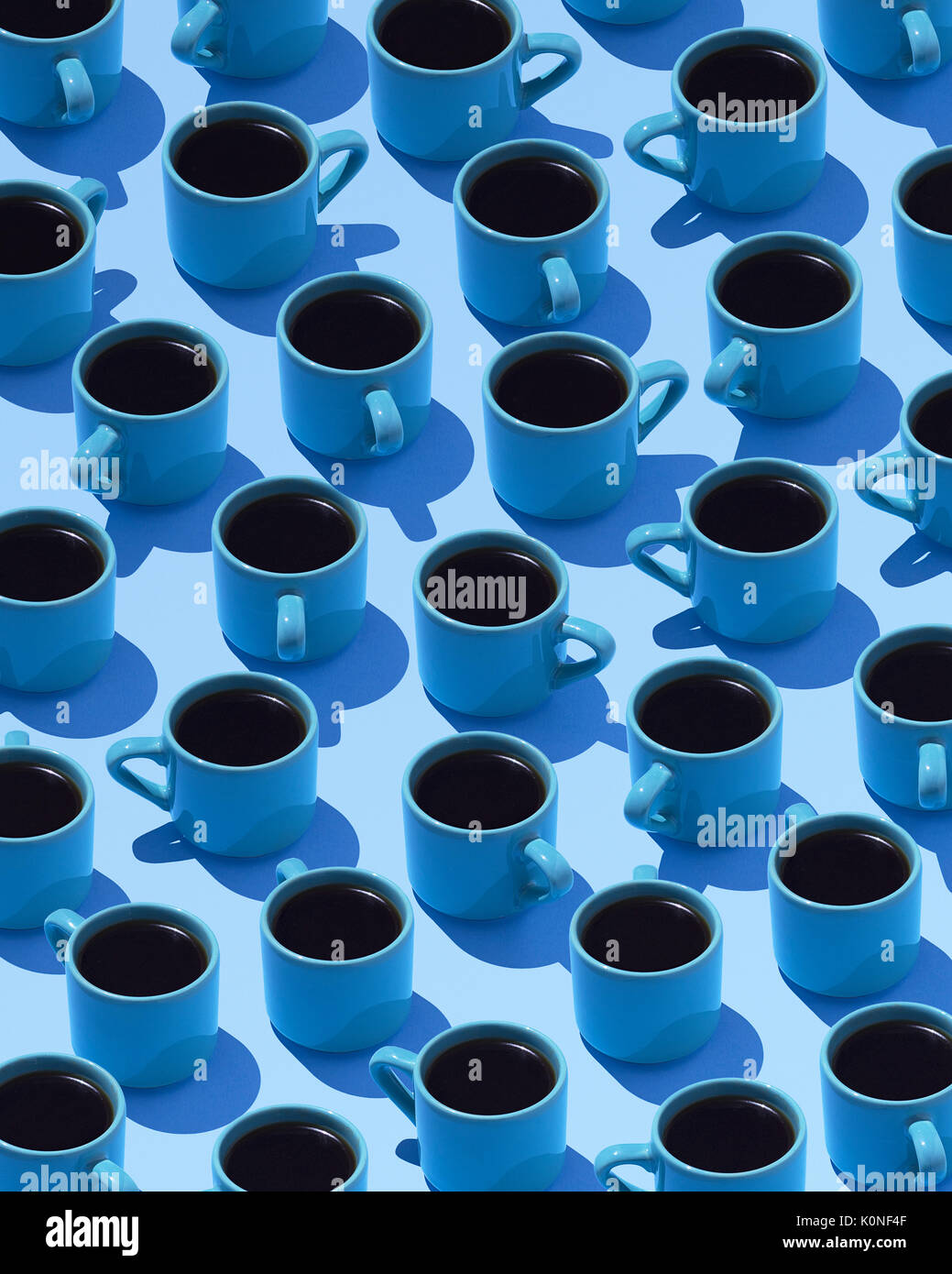 Blue coffee mugs on light blue ground, 3D Rendering Stock Photo