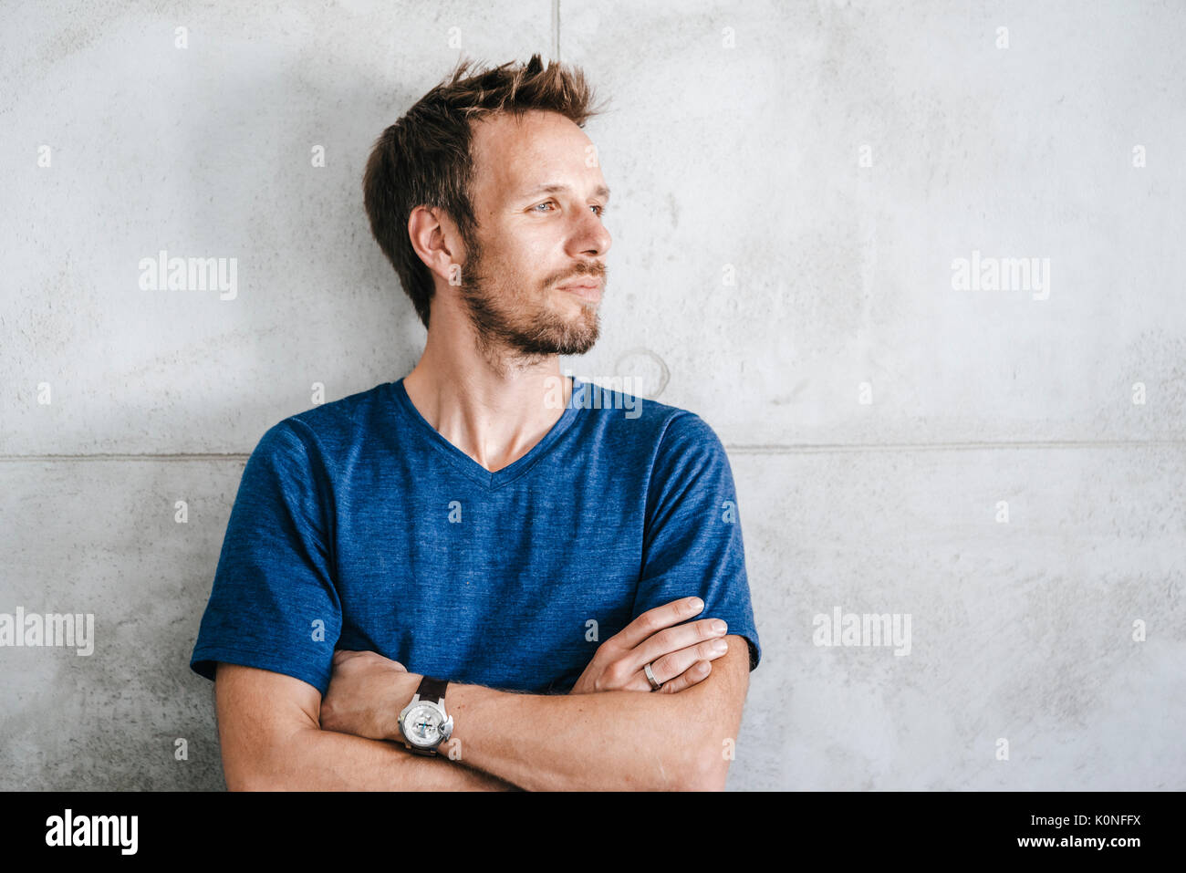 Portrait of a man standing in front of wall Stock Photo - Alamy