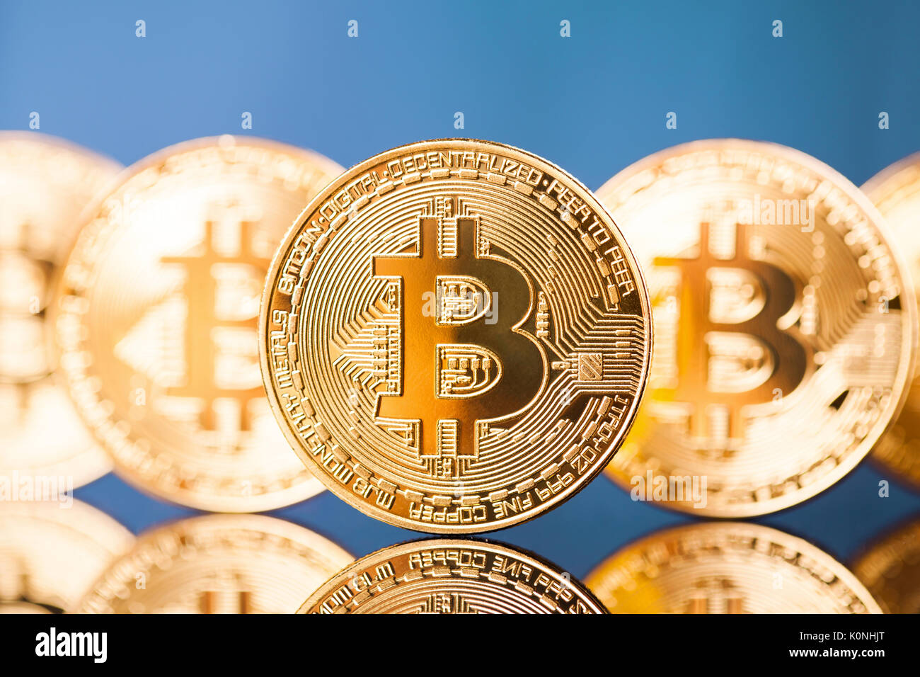 Five Virtual Coins Bitcoins On Blue Background Stock Photo