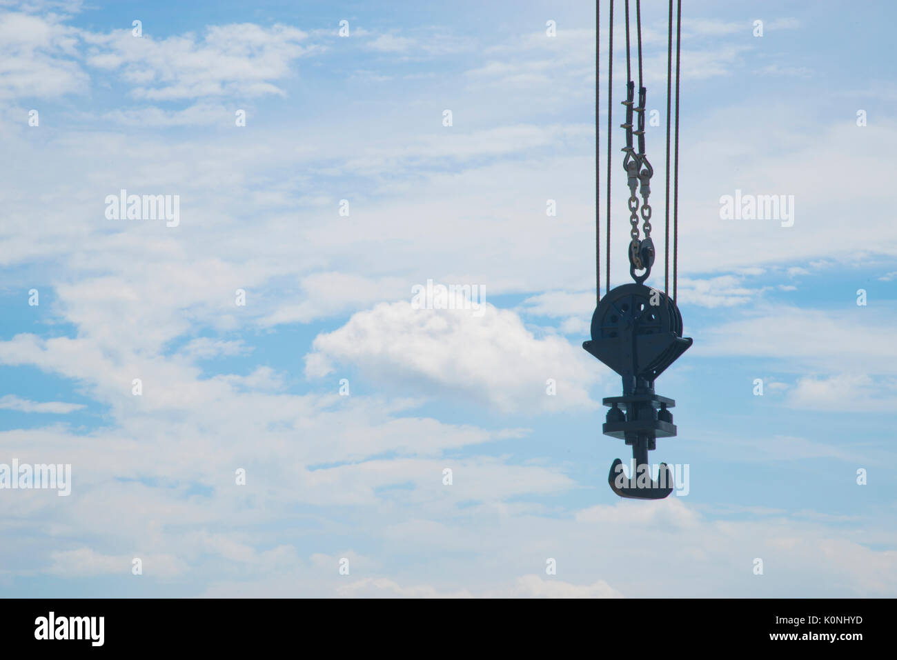 Hook of a crane against cloudy blue sky Stock Photo - Alamy