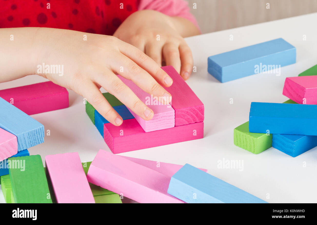 Child hands playing with colorful wooden blocks Stock Photo - Alamy