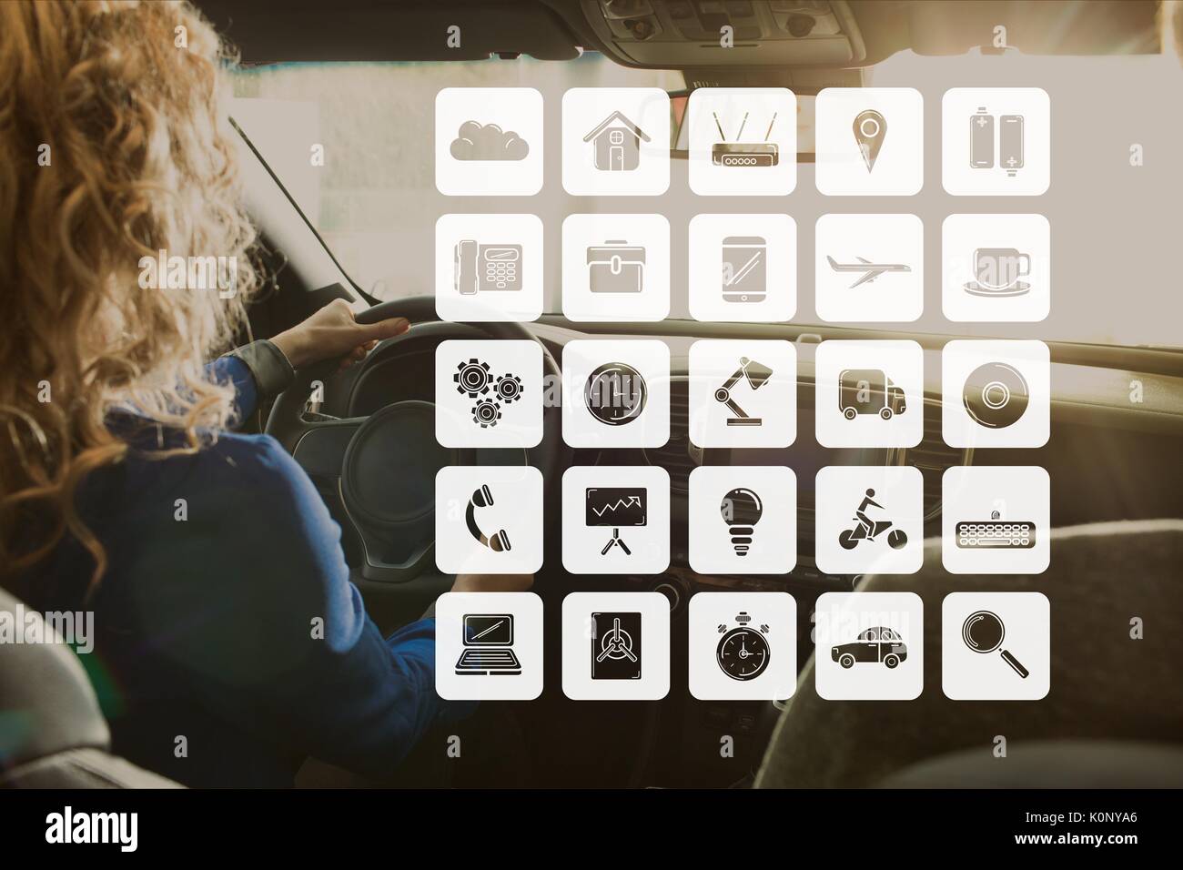 Digital composite of Icons against woman in the car Stock Photo