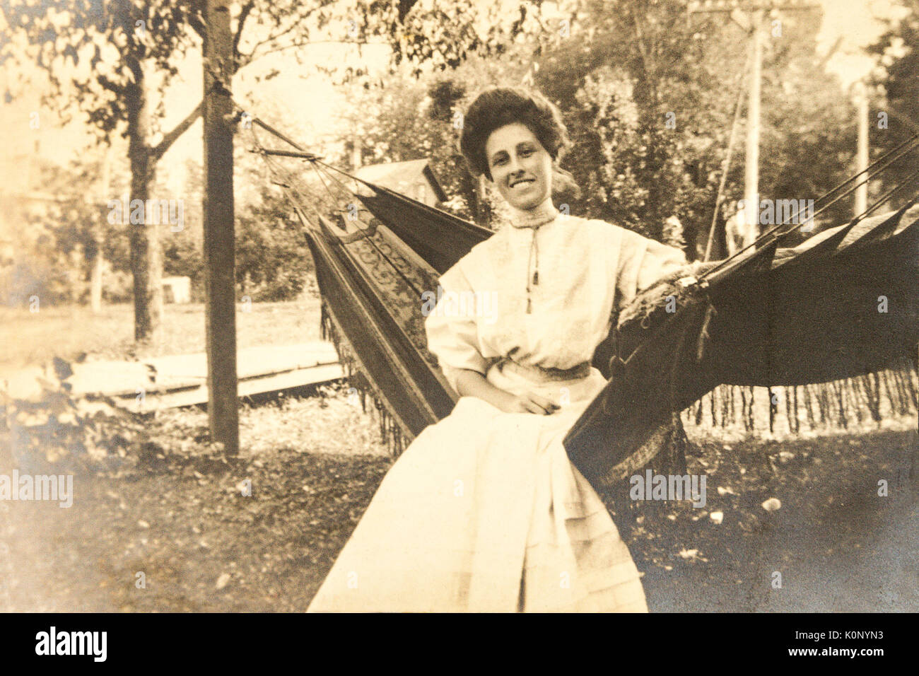A trim young woman resting in a hammock in 1907-1908 in MInnesota Stock Photo