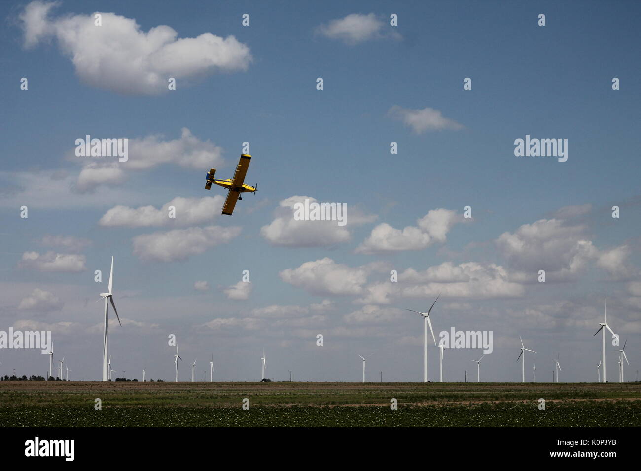 A cropduster on a low pass over his field. Stock Photo