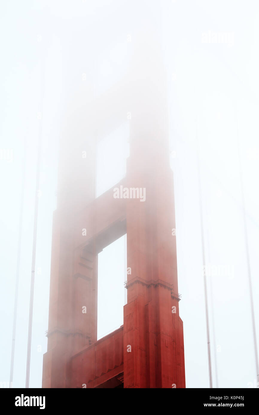 San Francisco Bay with top of Golden Gate Bridge suspension tower enveloped in fog Stock Photo