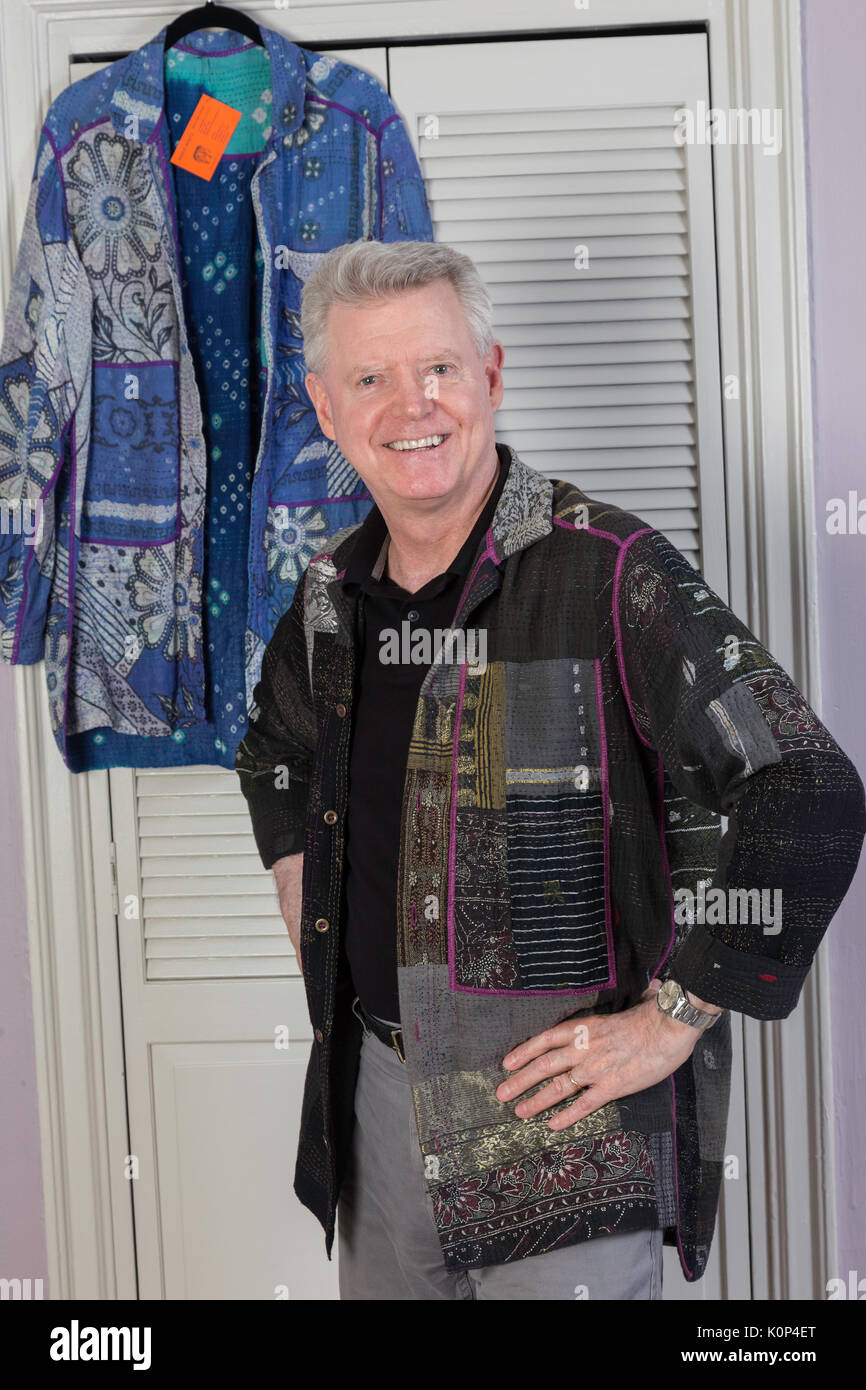 Senior man Trying on Designer Jacket in Dressing Room, NYC, USA Stock Photo