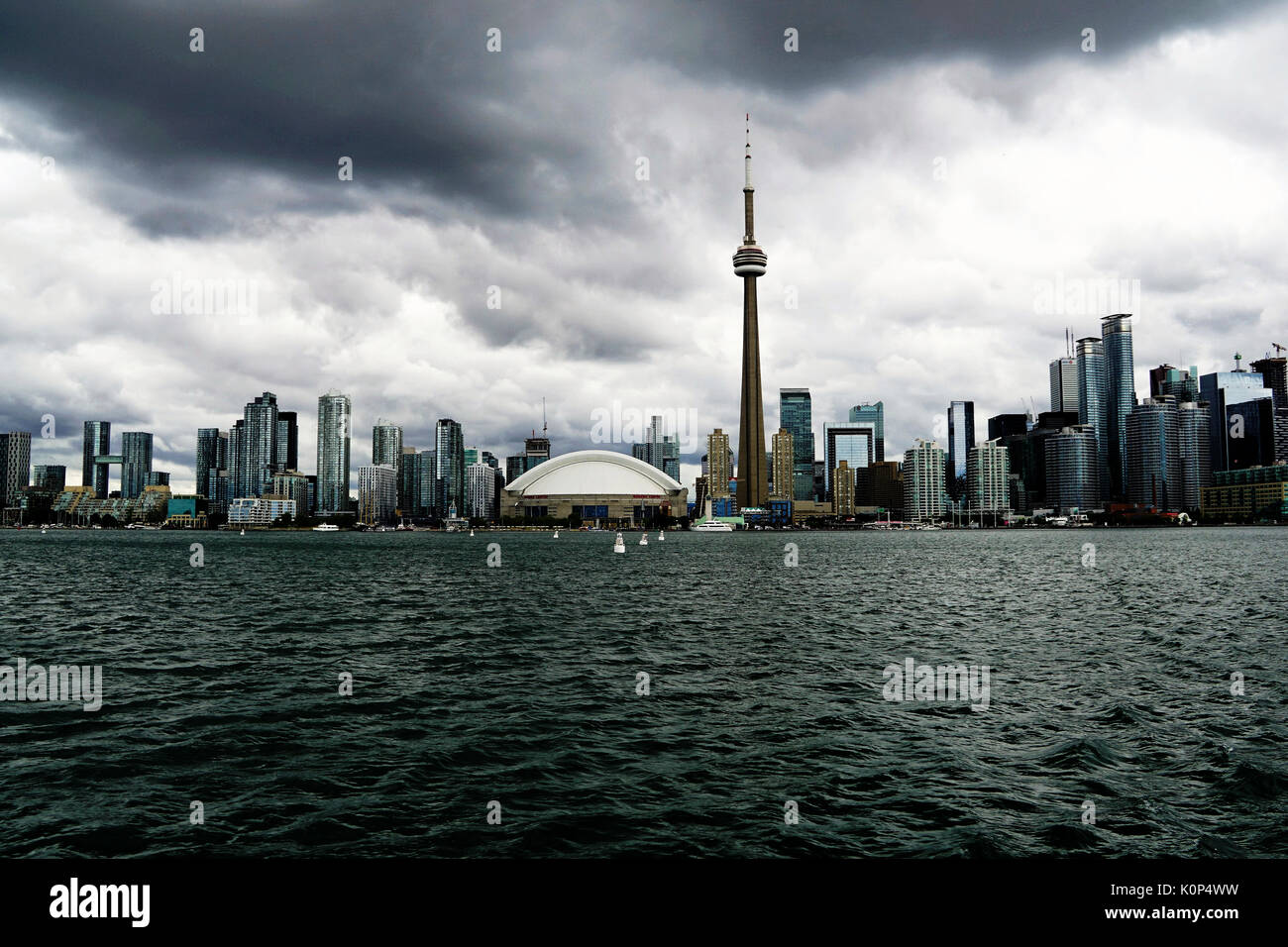 ocean view of toronto, otario canada cn tower and other skyscrapers/buildings against grey cloudy sky Stock Photo