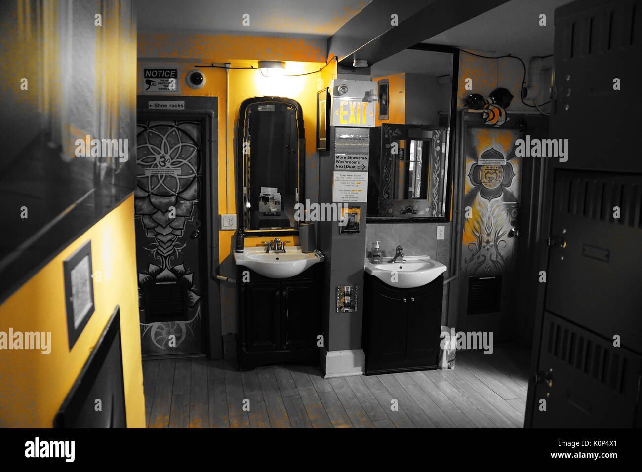 sinks, mirrors and murals in colour corrected yellow and grey bathroom/toilet Stock Photo