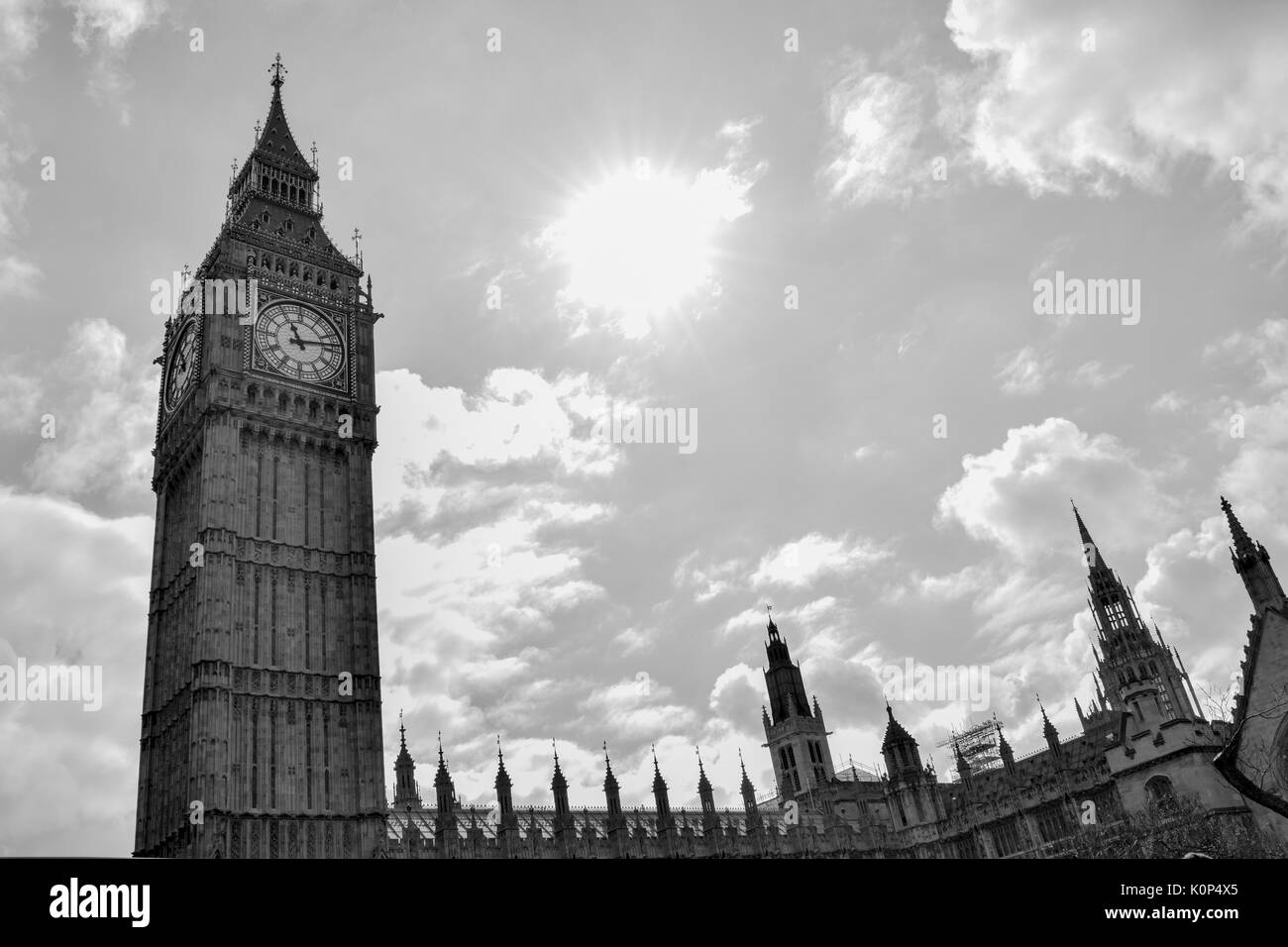 Big Ben, London, UK. A view of the popular London landmark, the clock tower known as Big Ben, showing 3pm as the time set against a blue and cloudy sky. Stock Photo