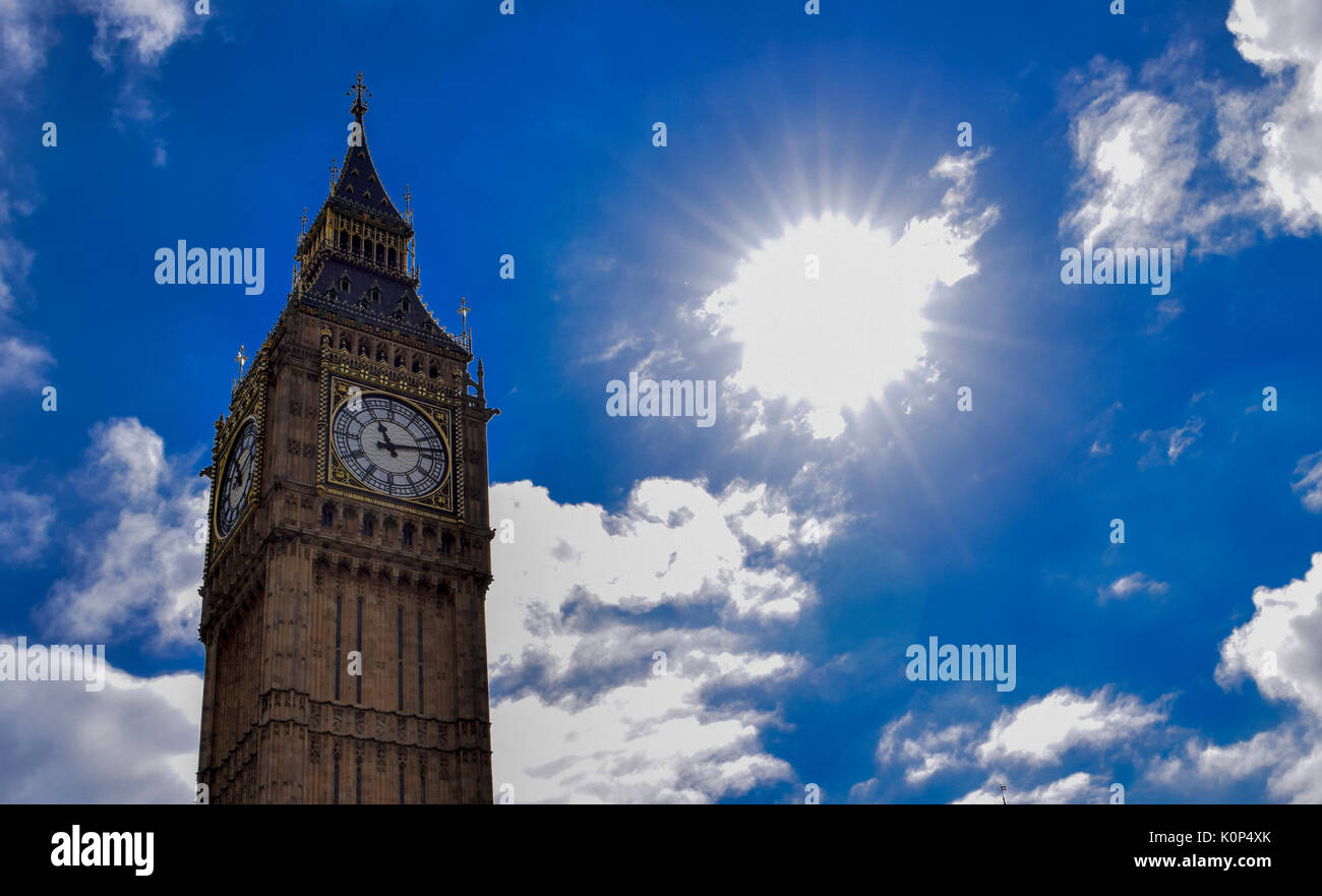 Big Ben, London, UK. A view of the popular London landmark, the clock tower known as Big Ben, showing 3pm as the time set against a blue and cloudy sky. Stock Photo