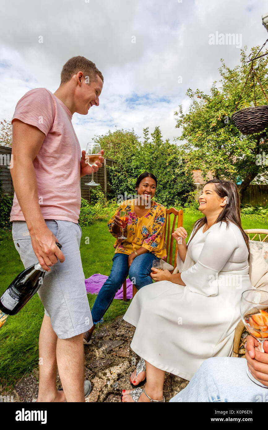 Family Members Laughing and Joking At A Family Barbecue, Sussex, UK Stock Photo