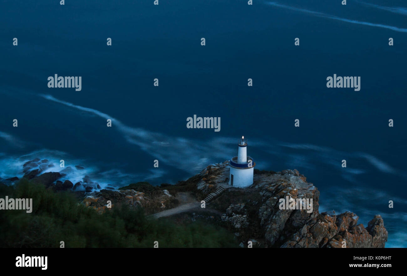 Night landscape in Cies islands, Vigo, Galicia, Spain, the coast line with a lighthouse and the sea backgrounds Stock Photo