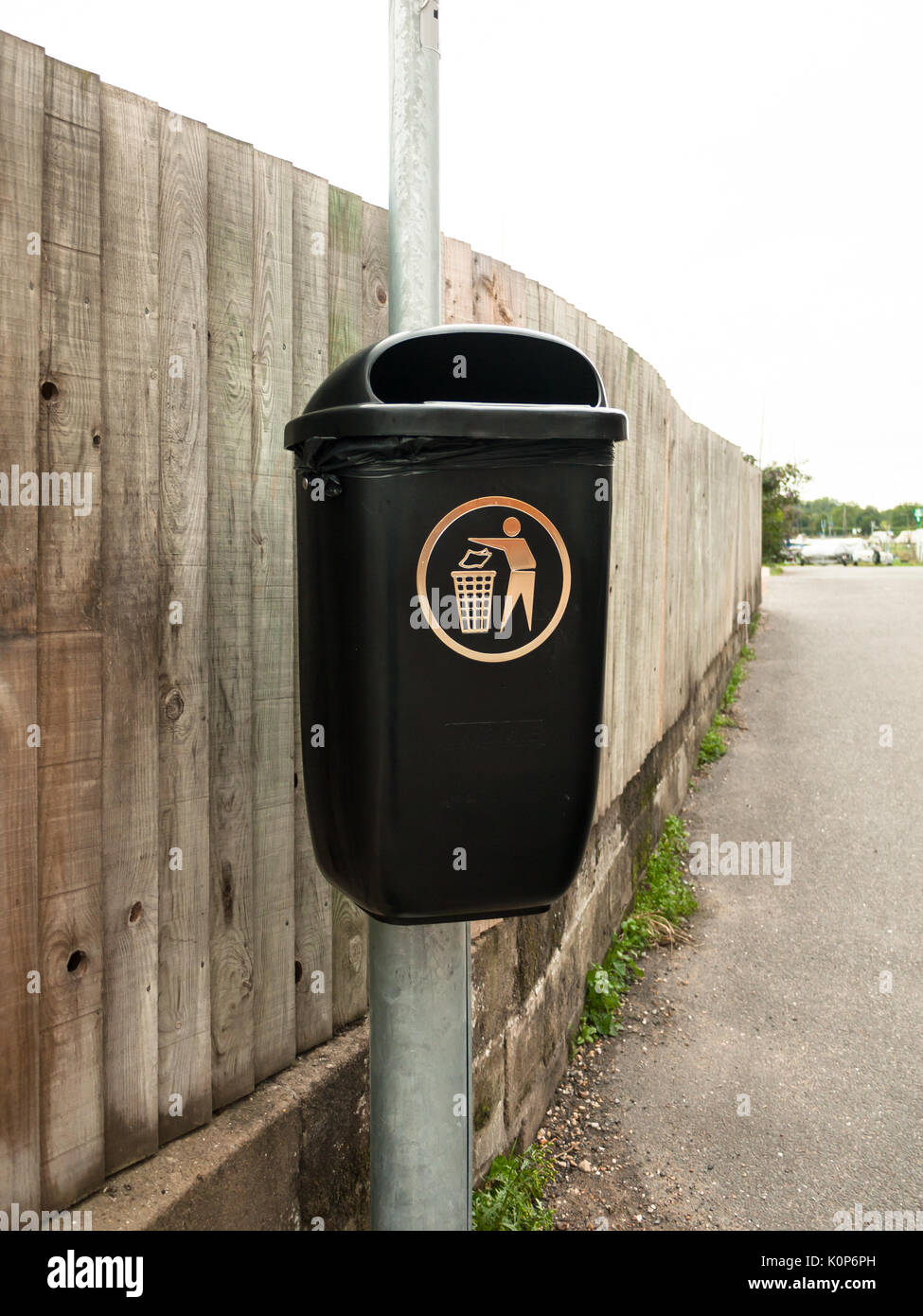 a public black bin on metal post isolated; England; UK Stock Photo Alamy