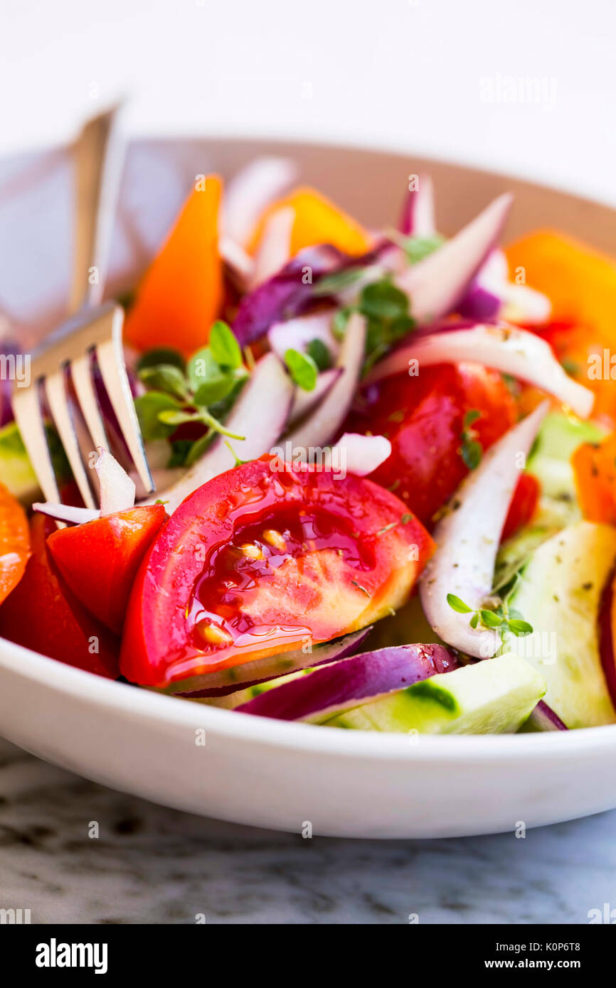 Tasty vegetables salad closeup with tomatoes, onion , cucumber and