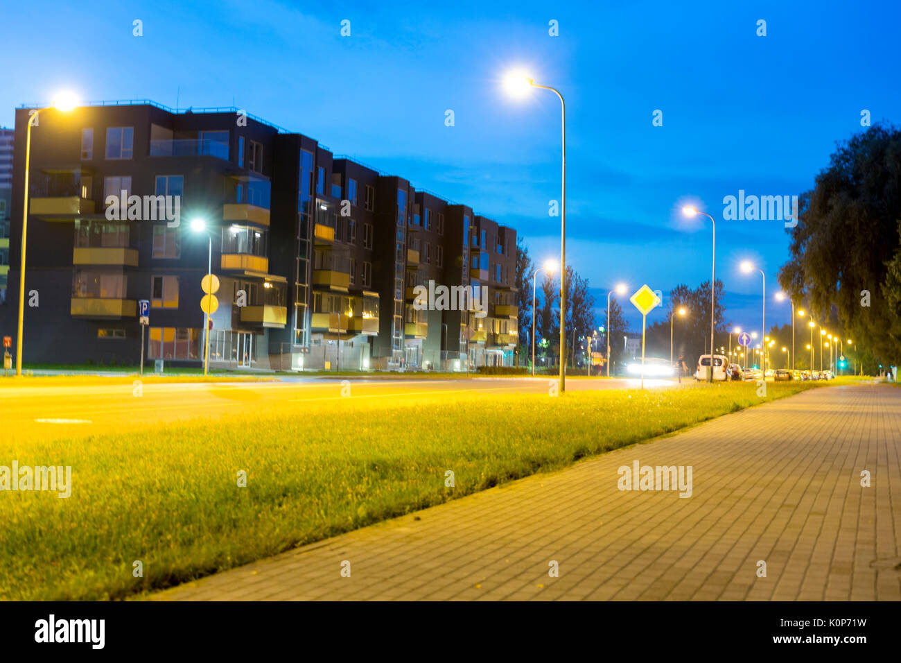 Night view of new modern residential district with park. Eco-friendly living in a city. Stock Photo