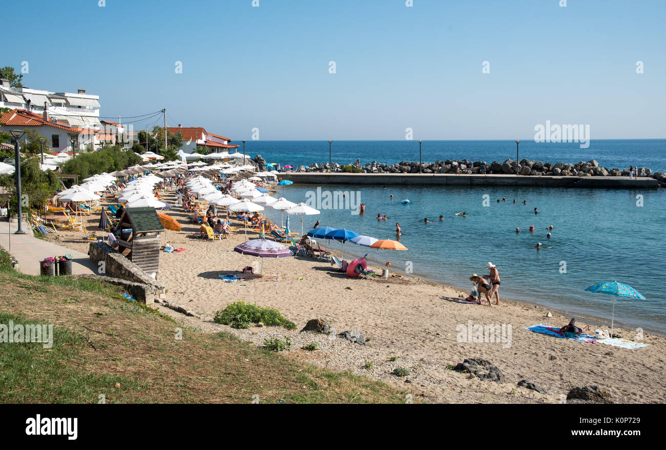 Loutra, Greece - July 25 2017:  People enjoying their summer vacations at the  idyllic beach of loutra at Kassandra, Halkidiki peninsula, Greece Stock Photo