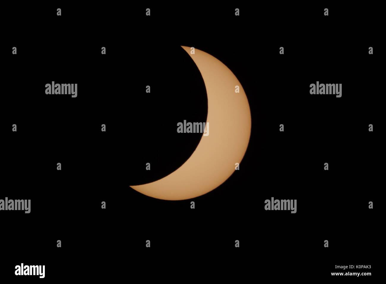 A crescent Sun is visible in the second partial eclipse phase of the Great American Eclipse on August 21, 2017. Stock Photo