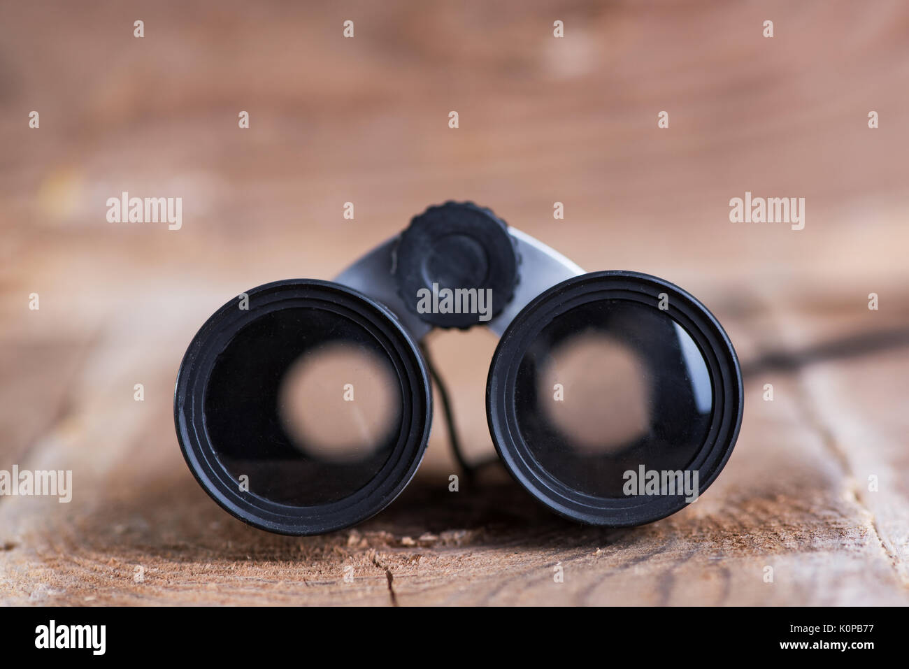Binoculars on wooden background Stock Photo