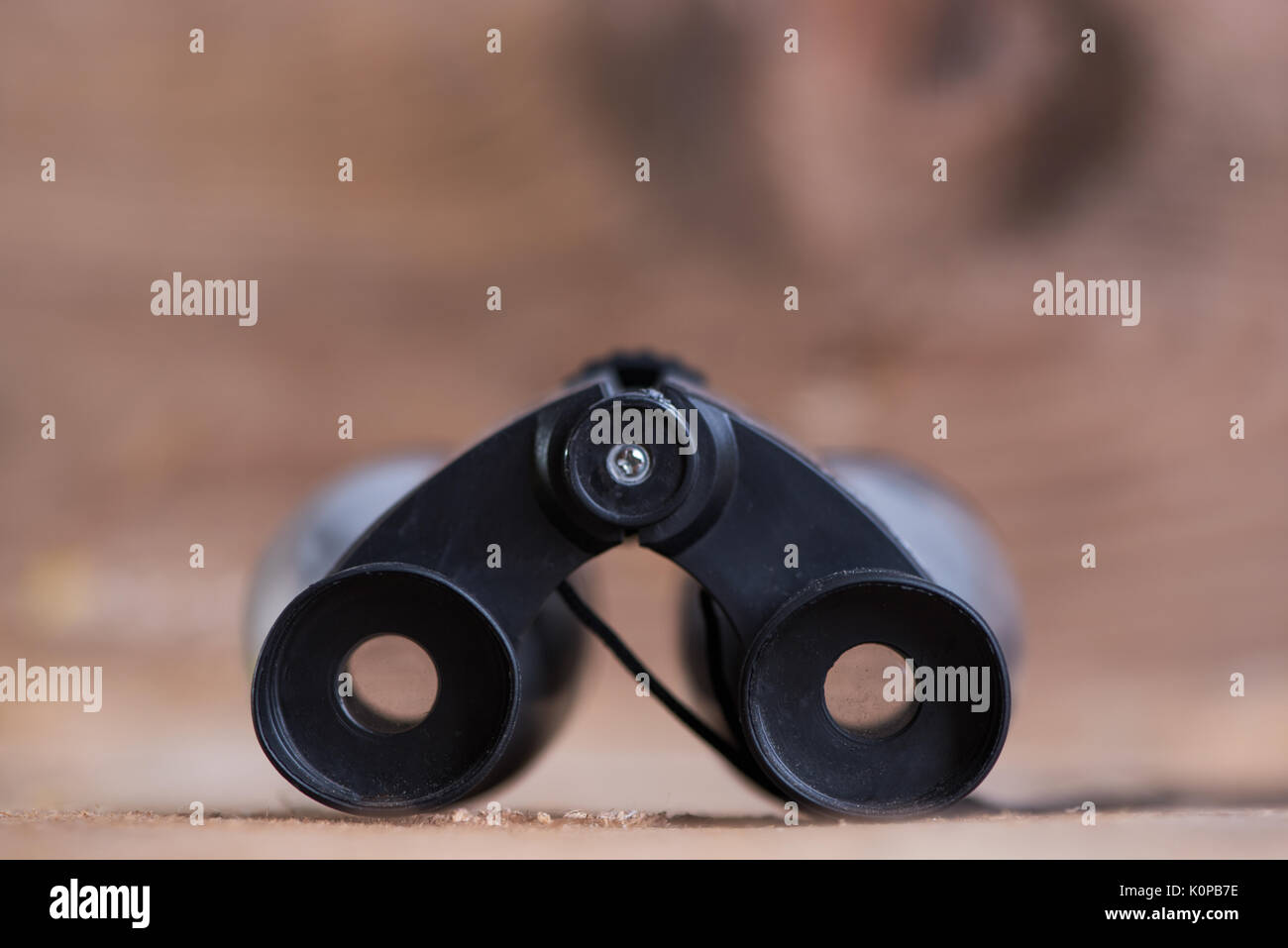 Binoculars on wooden background Stock Photo