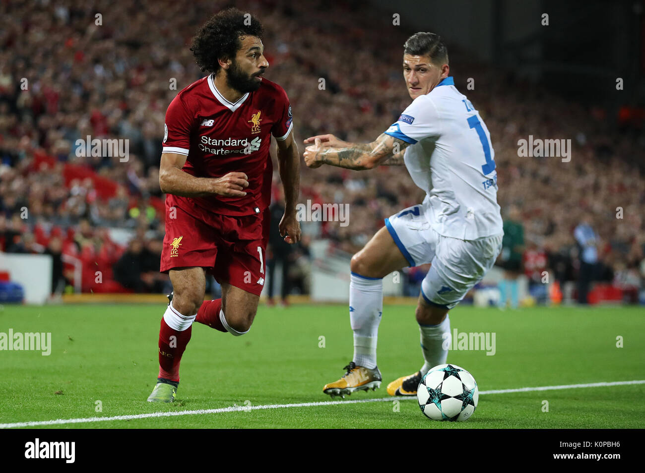Liverpool's Mohamed Salah (left) and Hoffenheim's Steven Zuber in action during the UEFA Champions League Play-Off, Second Leg match at Anfield, Liverpool. Stock Photo