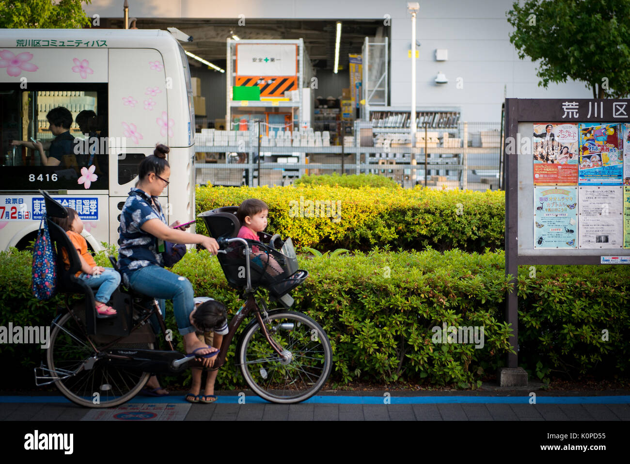 Mother carrying multiple children on a bicycle Stock Photo Alamy