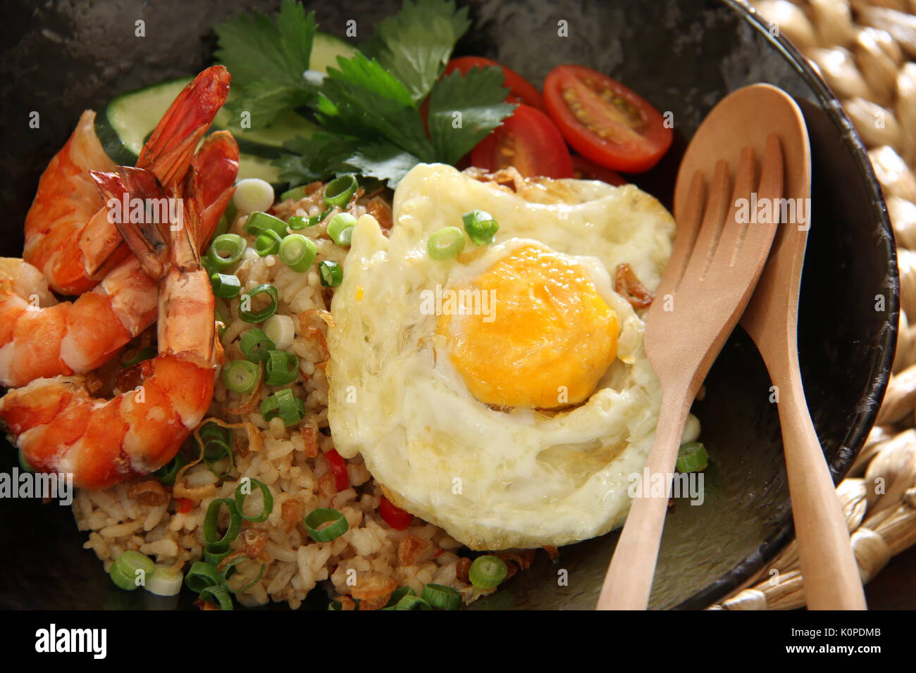 Nasi Goreng Gourmet, the Indonesian Fried Rice with Prawns and Sunny Side Egg Stock Photo