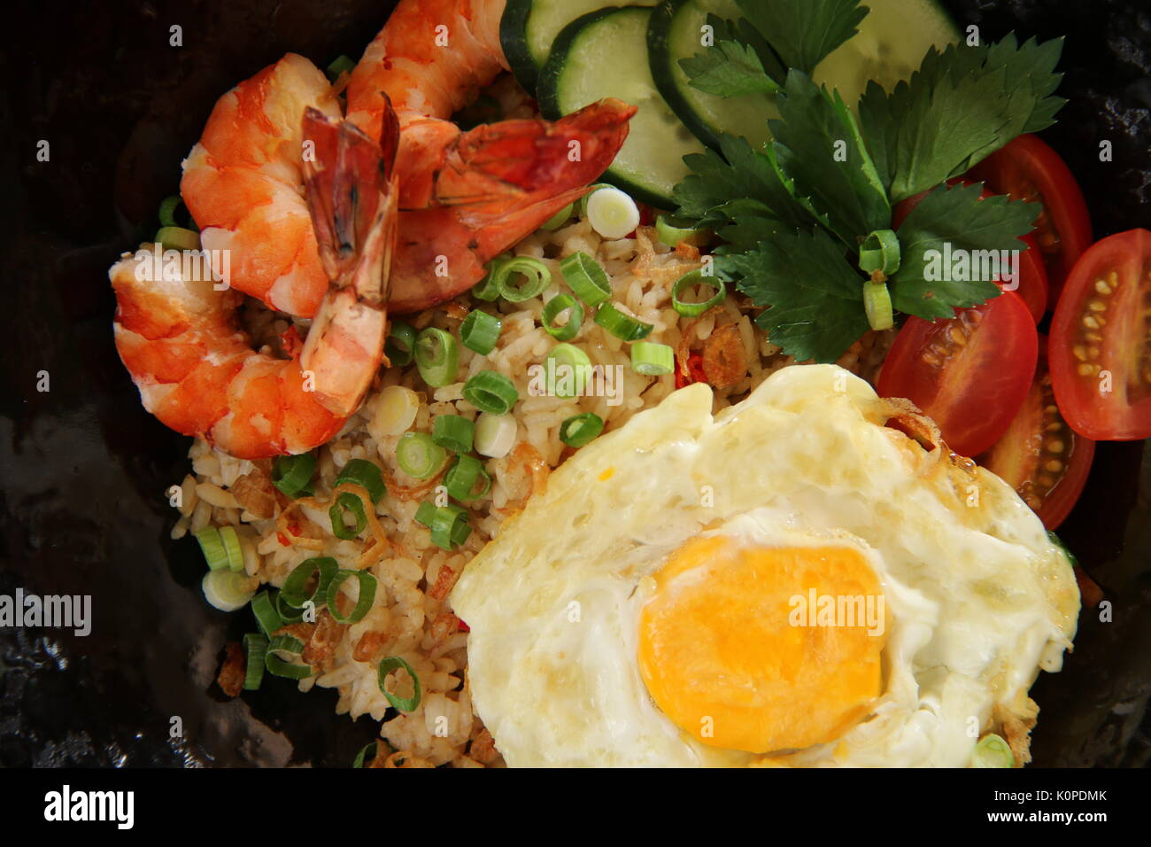 Nasi Goreng Gourmet, the Indonesian Fried Rice with Prawns and Sunny Side Egg Stock Photo