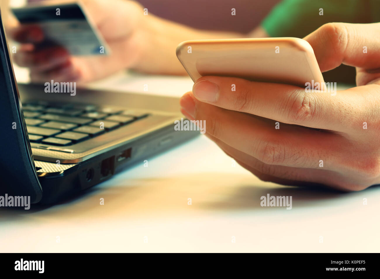Man using smartphone with credit card pay by credit card and laptop for online shopping Stock Photo